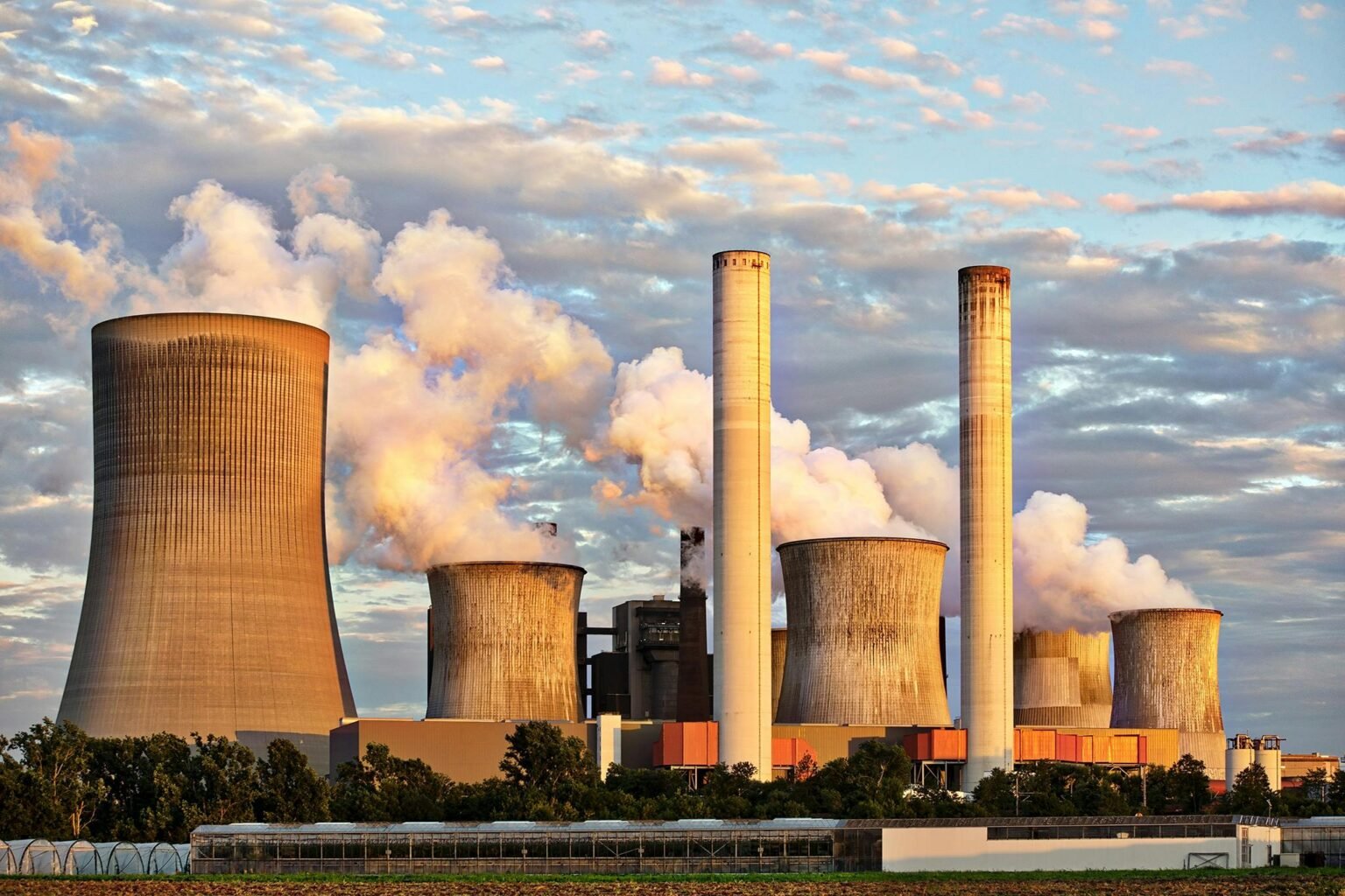 Offshore Rig Oil and Gas Safety Engineering 1 View of a power plant with smoke emissions under a cloudy sky, depicting industrial energy production.